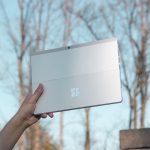 person holding white cardboard box