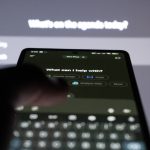 Person typing on smartphone with ai chatbot on screen.