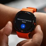 A close up of a person holding a smart watch