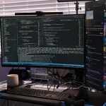 a computer monitor sitting on top of a desk