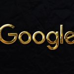 a gold google logo on a black background