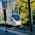 white and blue train on rail road during daytime