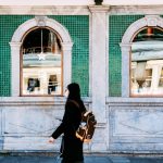 woman in black long sleeve shirt playing brown acoustic guitar