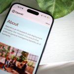 a cell phone sitting on top of a table next to a plant