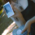 A woman holding a cell phone in her hand