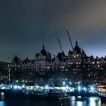a boat is docked in a harbor at night