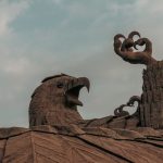 A statue of two birds on top of a building