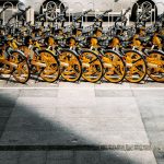 a group of bikes parked on a sidewalk