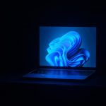 a macbook air laptop in a dark room