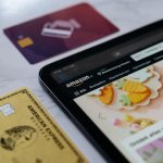 a smart phone sitting next to a credit card