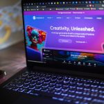 A laptop shows a website about ai creativity.
