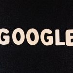 a close up of the word google on a black surface