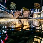 people walking on wooden bridge during night time
