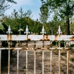white metal fence with brass padlock