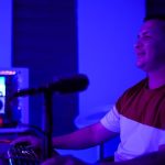 a man sitting in a chair in front of a microphone