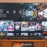 black flat screen tv turned on displaying man in black suit