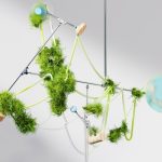 a mobile made of green plants and balls