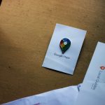 a google maps pin sitting on top of a piece of paper