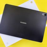 a black tablet sitting on top of a yellow table