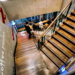 people walking on brown wooden staircase