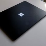 a laptop computer sitting on top of a white table