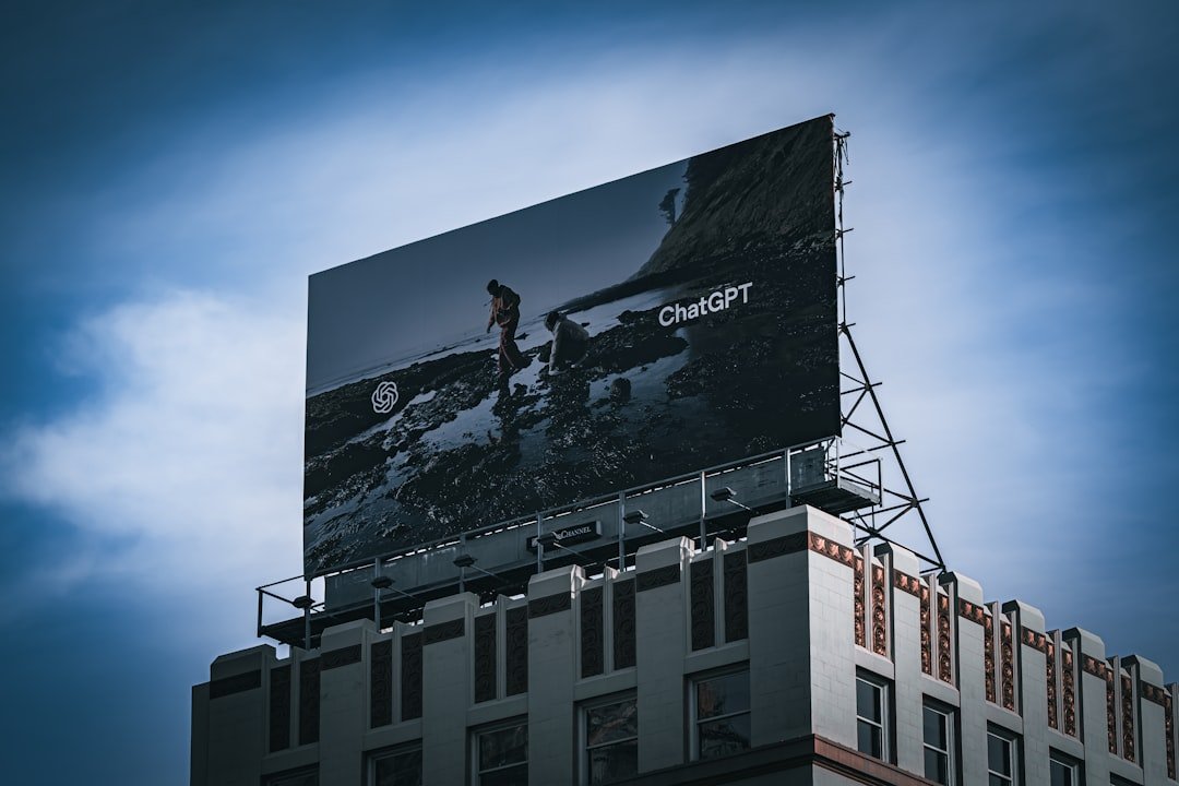 Billboard on top of a building against blue sky