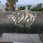 Bronze bull relief on a cylindrical monument