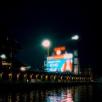 Bright stadium lights at night over water