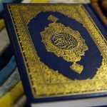 blue and gold book on blue and white textile