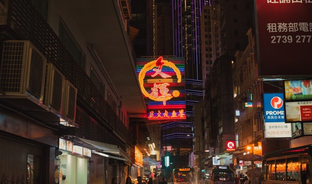 a busy city street at night with neon signs