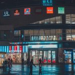 A group of people standing outside of a building at night