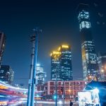 Modern cityscape with illuminated skyscrapers at night.