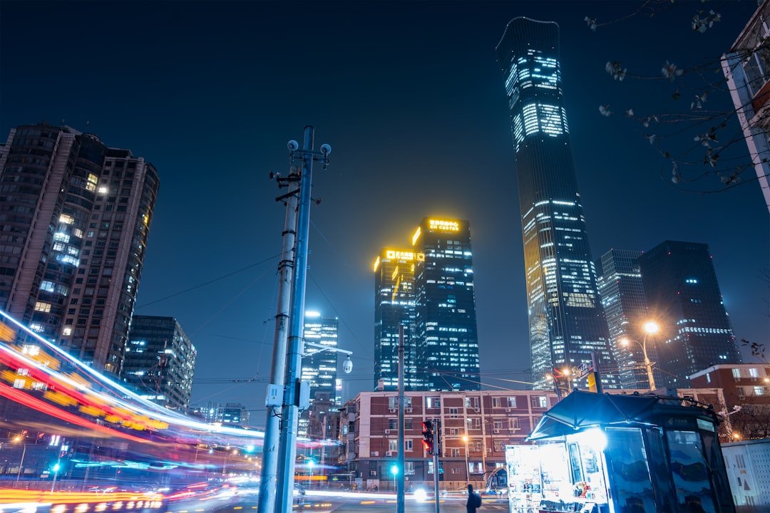 Modern cityscape with illuminated skyscrapers at night.