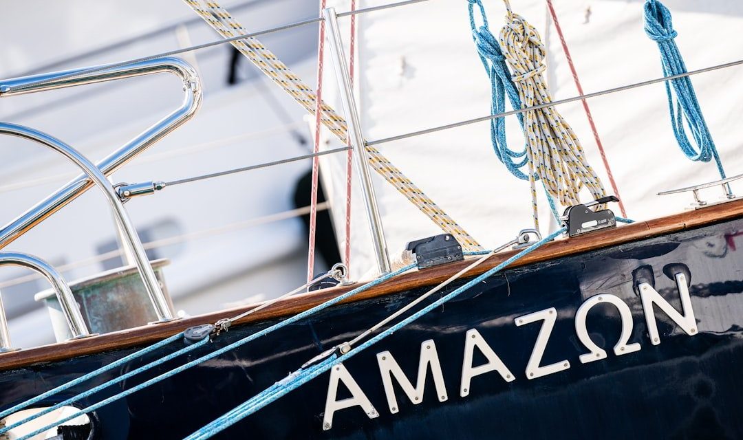 The name "amazon" written on the side of a sailboat.