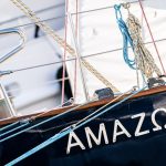 The name "amazon" written on the side of a sailboat.