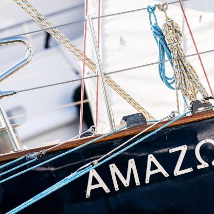 The name "amazon" written on the side of a sailboat.