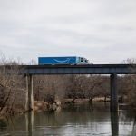 blue and white train on bridge during daytime