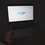 a person holding a laptop in their hand