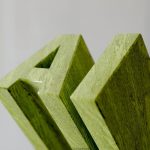 Green wooden letters spelling out "am"