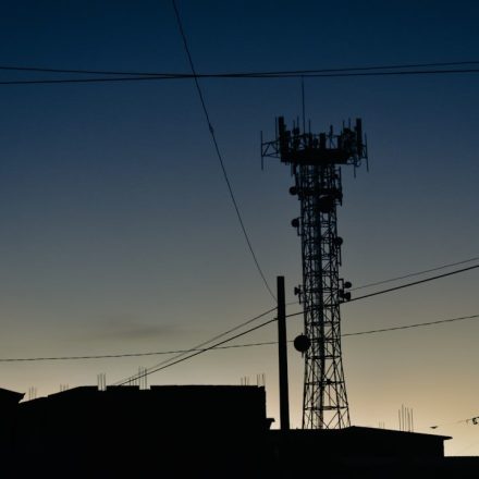a tower with a cell phone on top of it