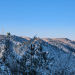 Snow-covered mountains under a clear blue sky