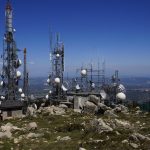 a group of cell towers sitting on top of a mountain
