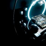 Circuit board with glowing ring and reflective spheres.