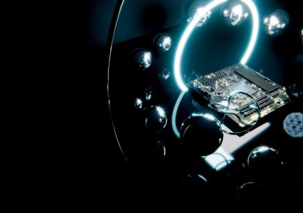 Circuit board with glowing ring and reflective spheres.