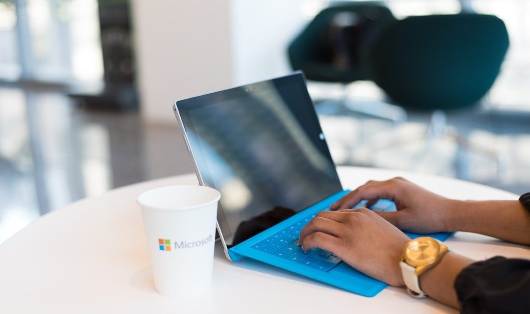 person using blue Microsoft Surface