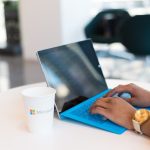 person using blue Microsoft Surface