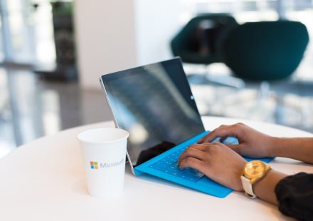 person using blue Microsoft Surface