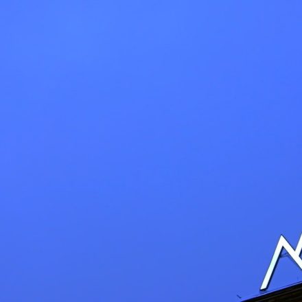 a blue sky with a sign on top of it