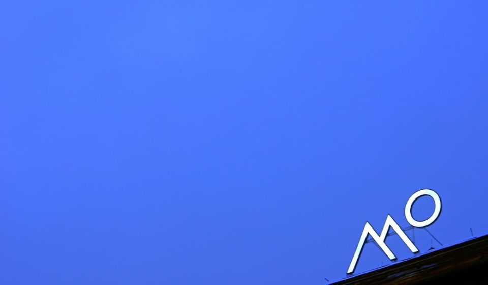 a blue sky with a sign on top of it