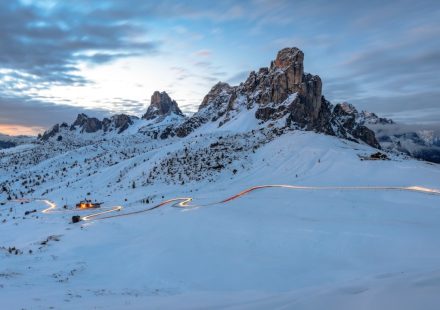 A mountain covered in snow under a cloudy sky